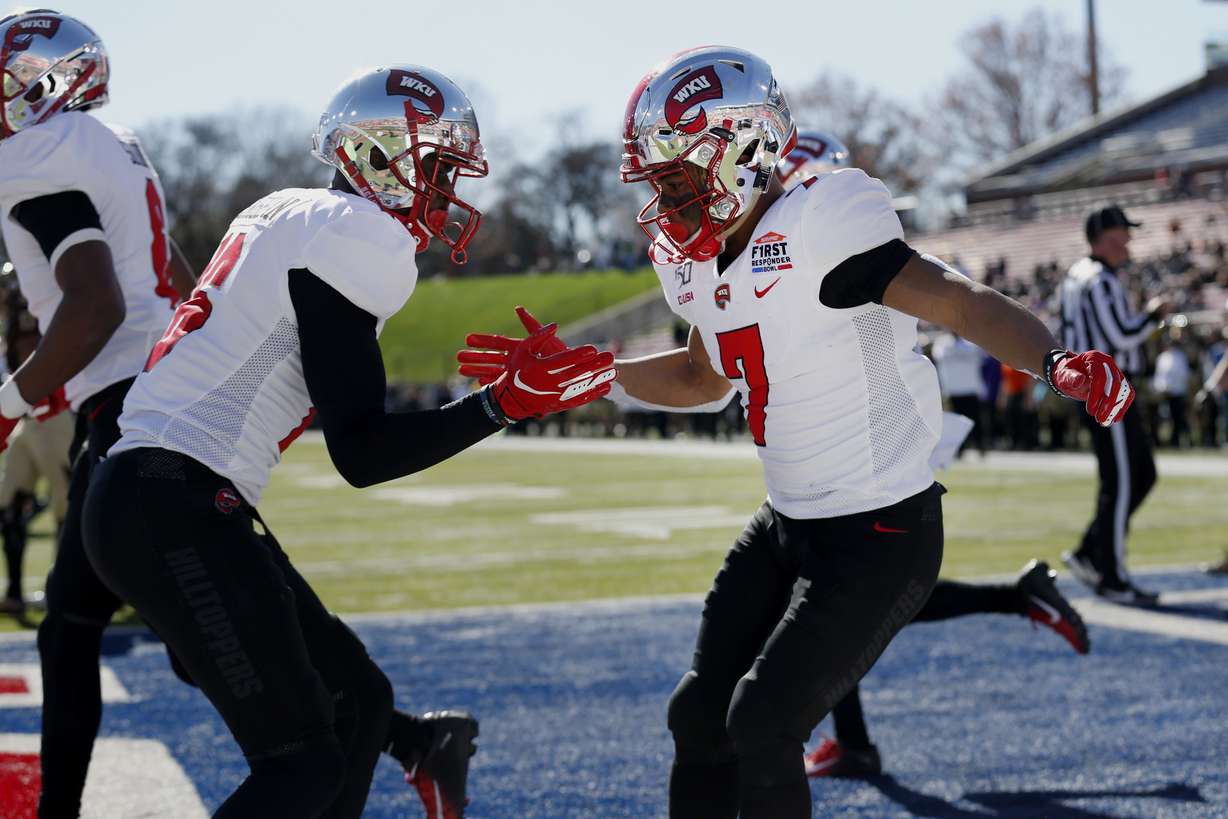 Western Kentucky wide receivers Jahcour Pearson, right, and Quin Jernighan, left, celebrate after a touchdown during the first half of the NCAA First Responder Bowl college football game against Western Michigan in Dallas, Monday, Dec. 30, 2019. (AP Photo/Roger Steinman)