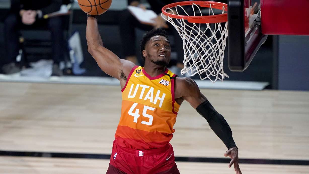 Utah Jazz's Donovan Mitchell (45) dunks against the Denver Nuggets during the second half of an NBA basketball first round playoff game Friday, Aug. 21, 2020, in Lake Buena Vista, Fla. (AP Photo/Ashley Landis, Pool)