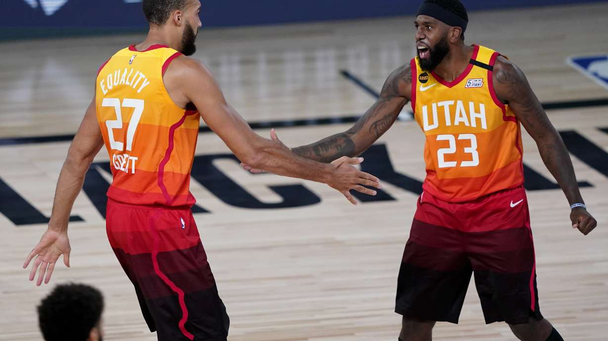 Utah Jazz's Rudy Gobert (27) celebrates with Royce O'Neale (23) during the first half of an NBA basketball first round playoff game against the Denver Nuggets Friday, Aug. 21, 2020, in Lake Buena Vista, Fla.
