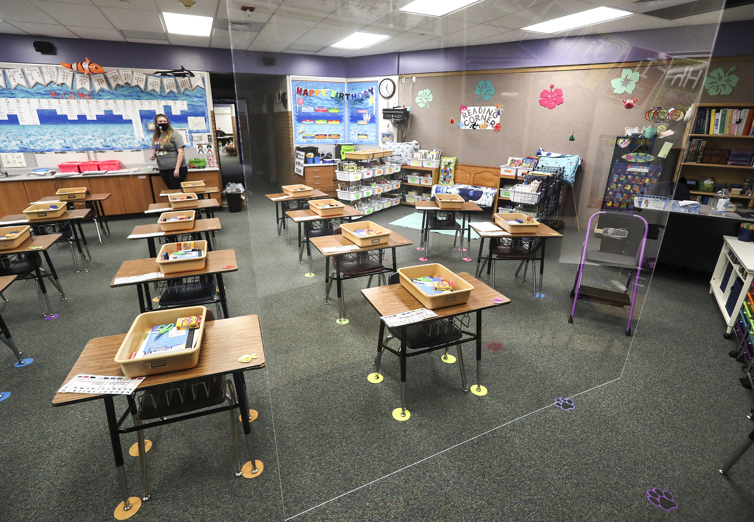 First grade teacher Jamie Greenwood looks at a large sheet of clear plastic that hangs from the ceiling in her classroom at Westvale Elementary School in West Jordan on Wednesday, Aug. 19, 2020.  Greenwood will stand behind the plastic when she teaches her class. The Jordan Board of Education will appropriate $500 to each classroom teacher for personal protective equipment and supplies.