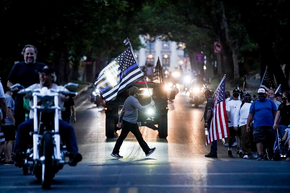 People walk, ride motorcycles and drive trucks in a âBlue Lives Matterâ march in support of police near the Capitol in Salt Lake City on Saturday, Aug. 22, 2020.