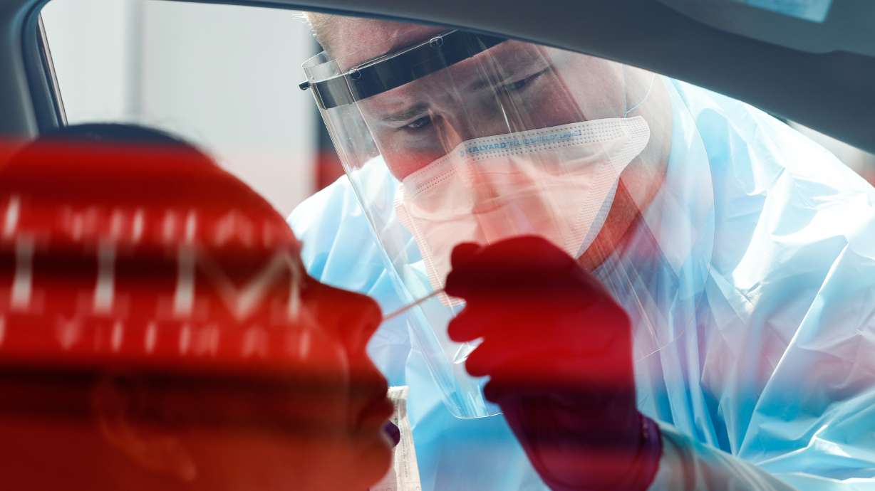 Dakota Sliva administers a COVID-19 test to a patient as University of Utah Health's Wellness Bus visits the Sorenson Multicultural Center in Salt Lake City on Thursday, Aug. 20, 2020.
