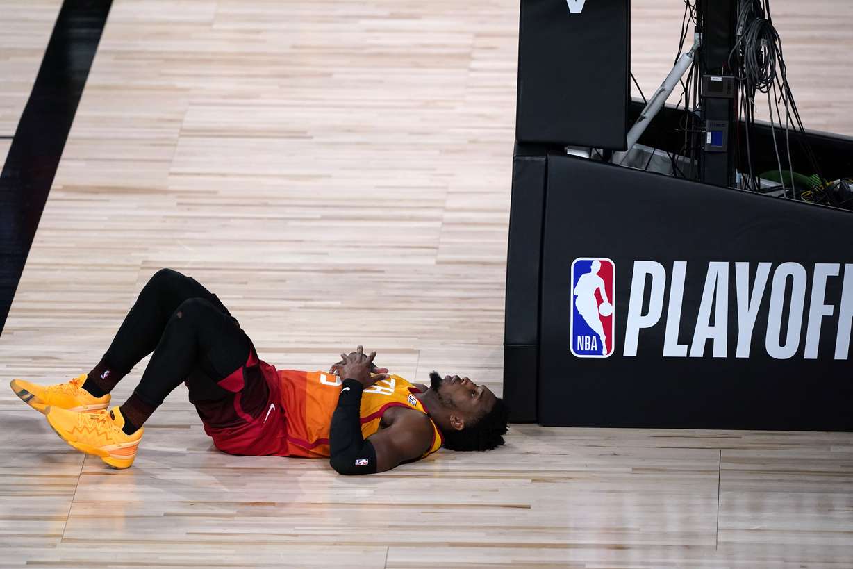 Utah Jazz's Donovan Mitchell lies on the court after being fouled during the second half of an NBA basketball first round playoff game against the Denver Nuggets Sunday, Aug. 23, 2020, in Lake Buena Vista, Fla.
