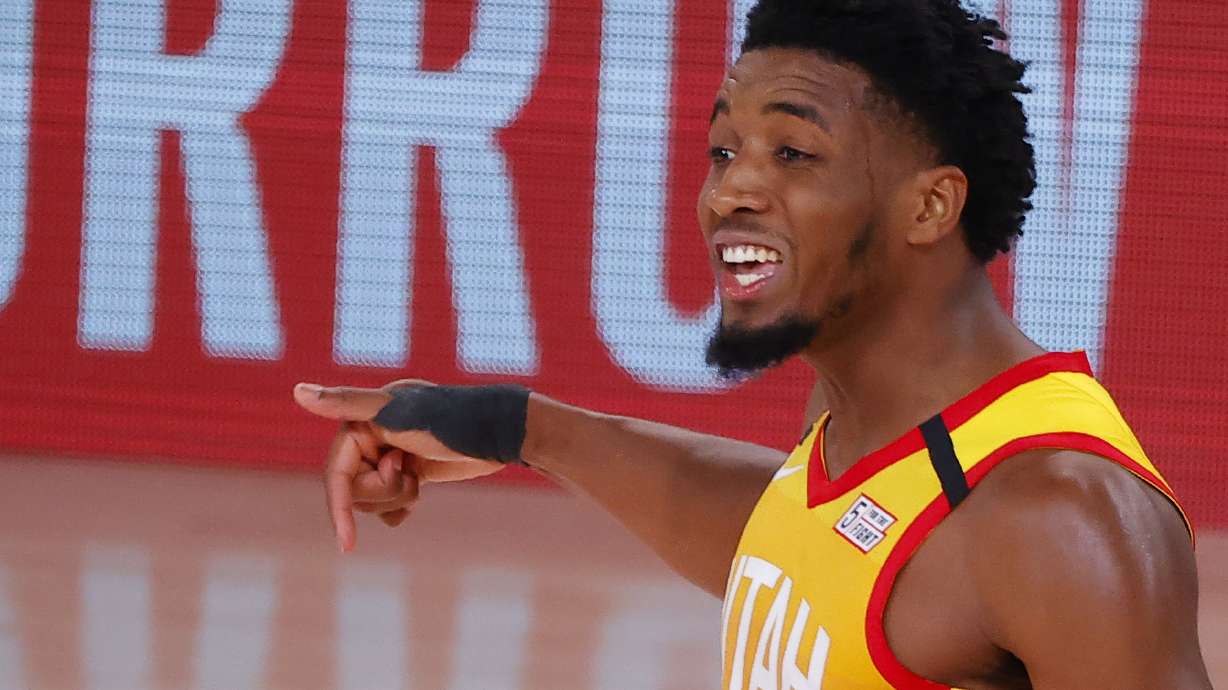 Utah Jazz's Donovan Mitchell celebrates a 3-point basket against the Denver Nuggets during the fourth quarter of Game 4 of an NBA basketball first-round playoff series, Sunday, Aug. 23, 2020, in Lake Buena Vista, Fla. (Kevin C. Cox/Pool Photo via AP)