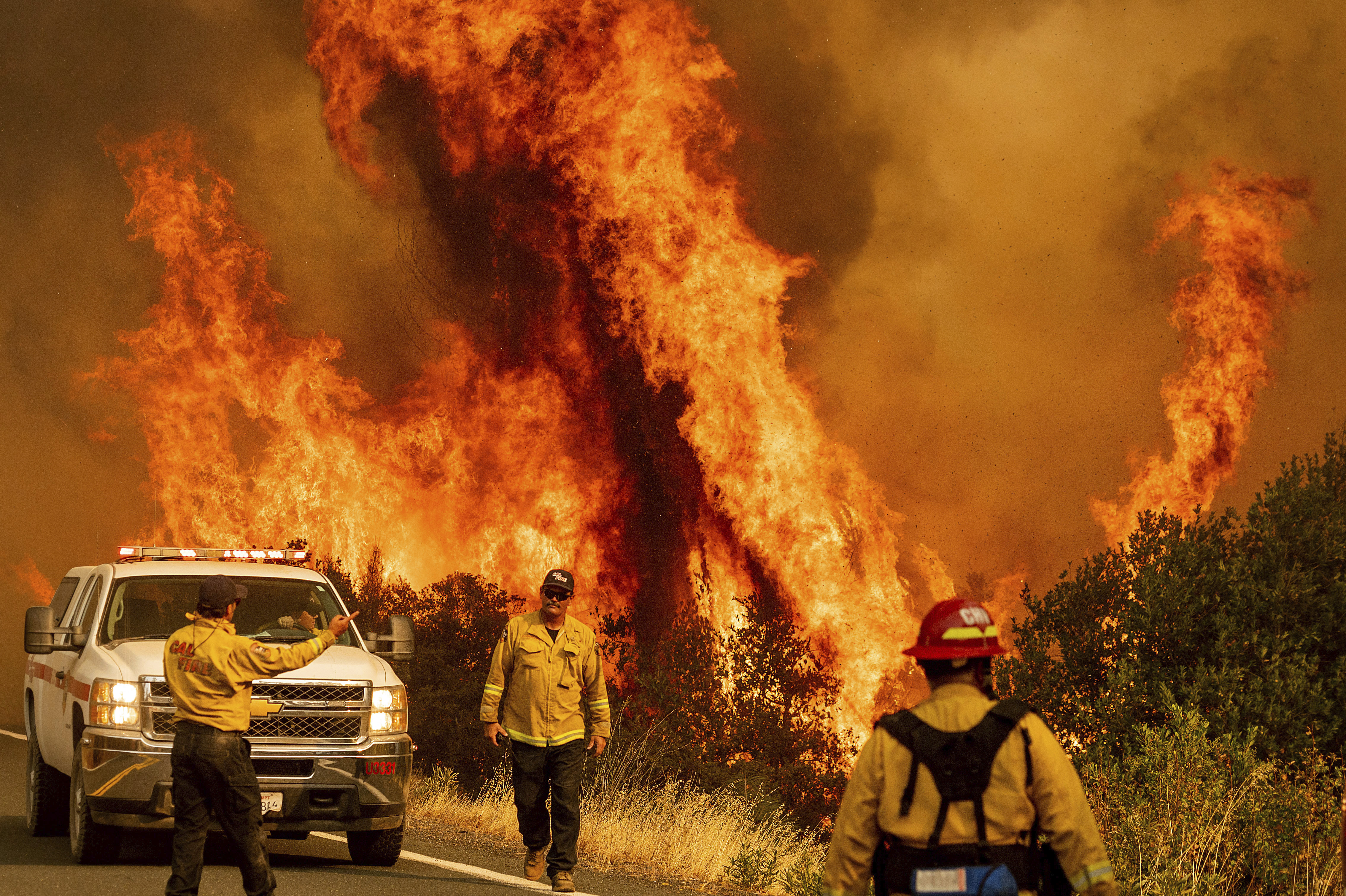 Flames from the LNU Lightning Complex fires leap above Butts Canyon Road on Sunday, Aug. 23, 2020, as firefighters work to contain the blaze in unincorporated Lake County, Calif. (AP Photo/Noah Berger) [Aug-24-2020]