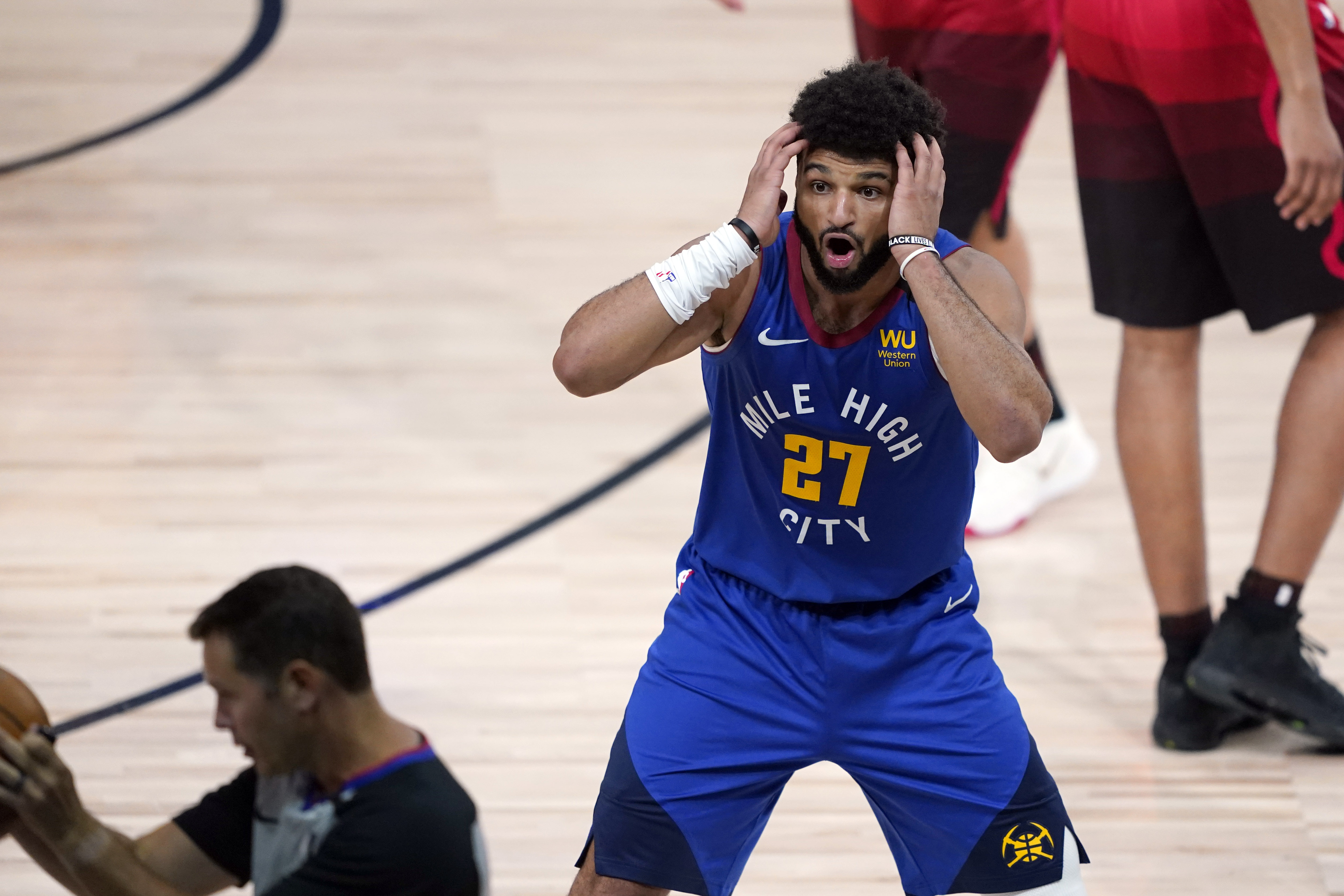 Denver Nuggets' Jamal Murray (27) reacts to a call during the first half of an NBA basketball first round playoff game against the Utah Jazz Sunday, Aug. 23, 2020, in Lake Buena Vista, Fla. 