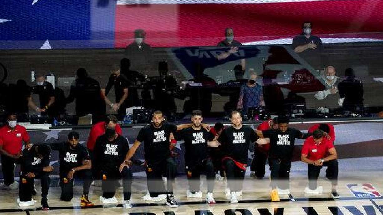 The Utah Jazz kneel during the national anthem prior to an NBA basketball first round playoff game against the Denver Nuggets, Friday, Aug. 21, 2020, in Lake Buena Vista, Fla.