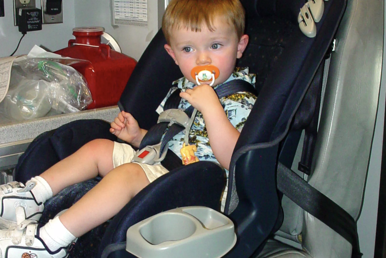 Zyon Bruce, 18 months, who walked away from a crash with his family in 2004, is pictured in a car seat in an ambulance after the crash. Intermountain Primary Children’s Hospital on Tuesday celebrated 30 years of the Hold On To Dear Life campaign, which advocates for car safety, and announced a new aspect of the campaign that will focus on adolescent mental well-being. 