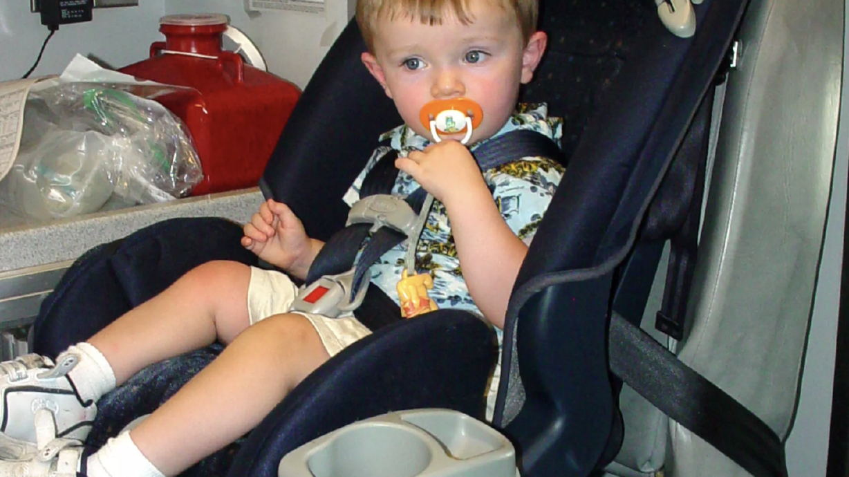 Zyon Bruce, 18 months, who walked away from a crash with his family in 2004, is pictured in a car seat in an ambulance after the crash. Intermountain Primary Children’s Hospital on Tuesday celebrated 30 years of the Hold On To Dear Life campaign, which advocates for car safety, and announced a new aspect of the campaign that will focus on adolescent mental well-being.