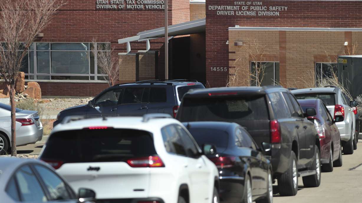 Hundreds of cars wait in line at the Division of Motor Vehicles drive-thru window in Draper on Friday, April 3, 2020. Some waited in line for hours.