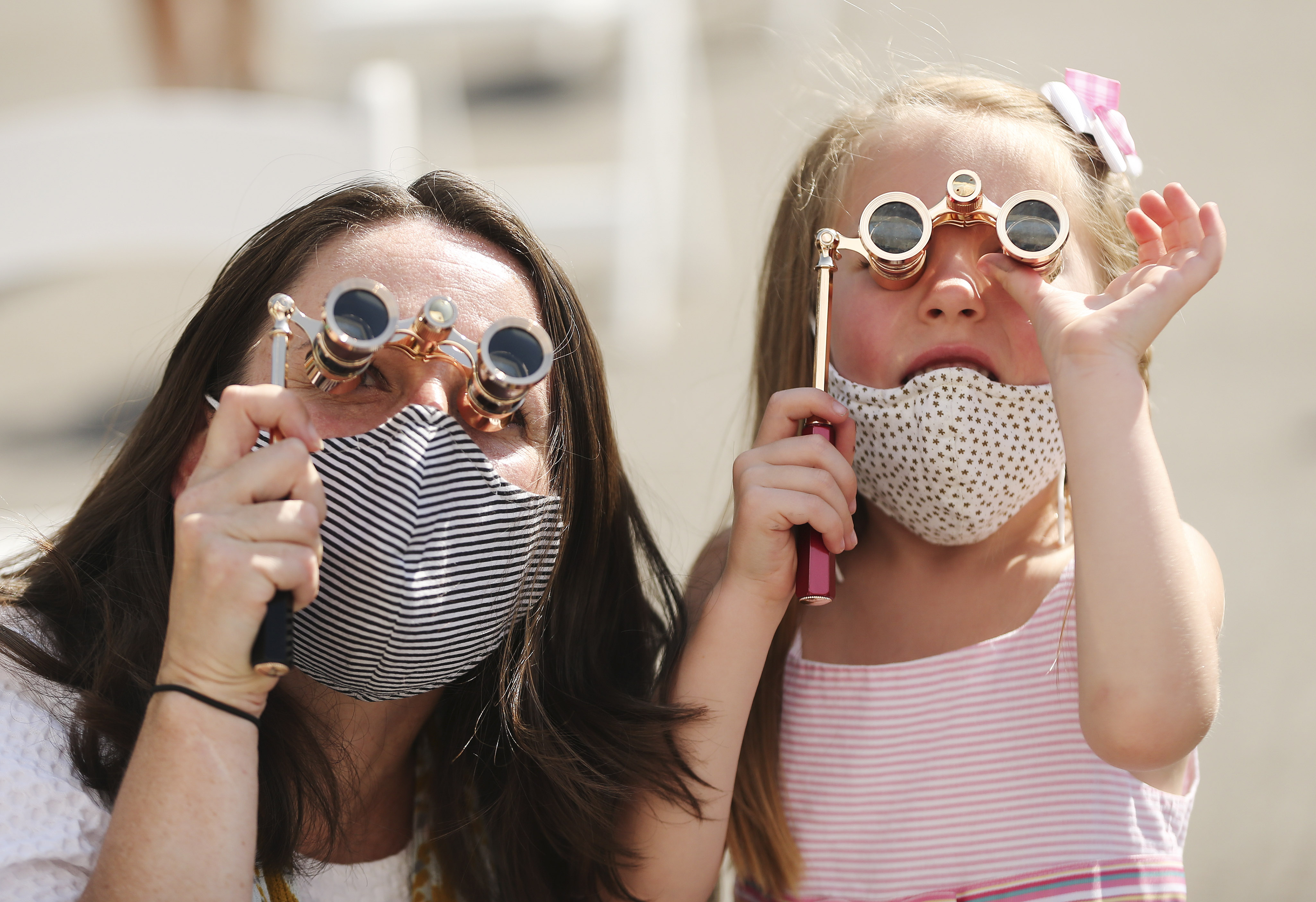 Holly Yocom and daughter Harper, 5, look at their images in the “Utah Women 2020” mural on the Dinwoodey Building in Salt Lake City during its unveiling on Wednesday, Aug. 26, 2020. The mural, commissioned by Zions Bank in honor of women’s suffrage, depicts images of 250 Utah women past and present.