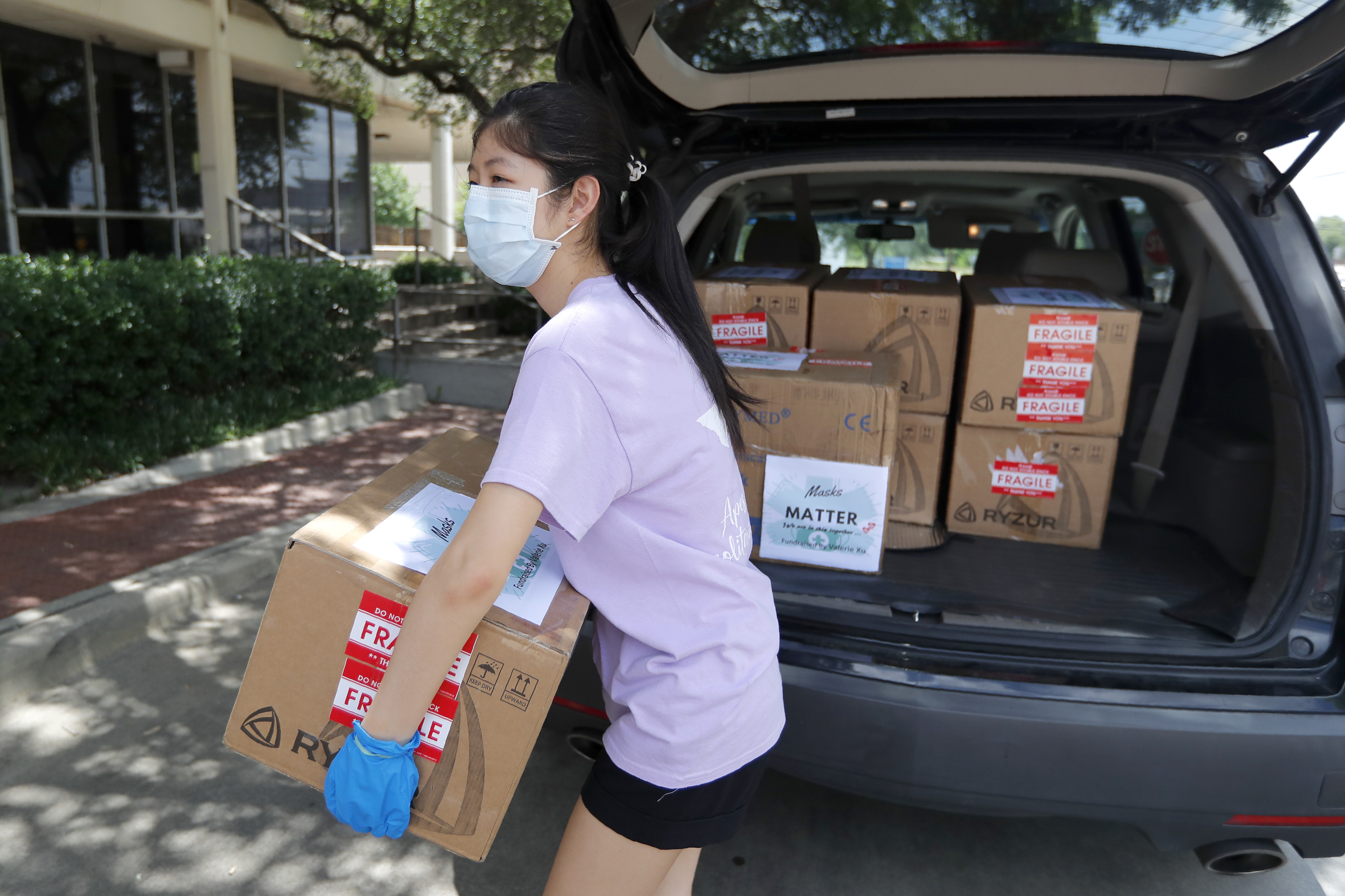 Valerie Xu, 15, delivers a donation, boxes of mask to UT Southwestern Medical Center in Dallas, Friday, June 5, 2020. Xu is among teens across the U.S. who decided to take action as the coronavirus pandemic took hold, doing everything from delivering groceries to older people to offering online tutoring, to emailing sick children and to raising money to help feed the hungry. (AP Photo/Tony Gutierrez) [Aug-27-2020]