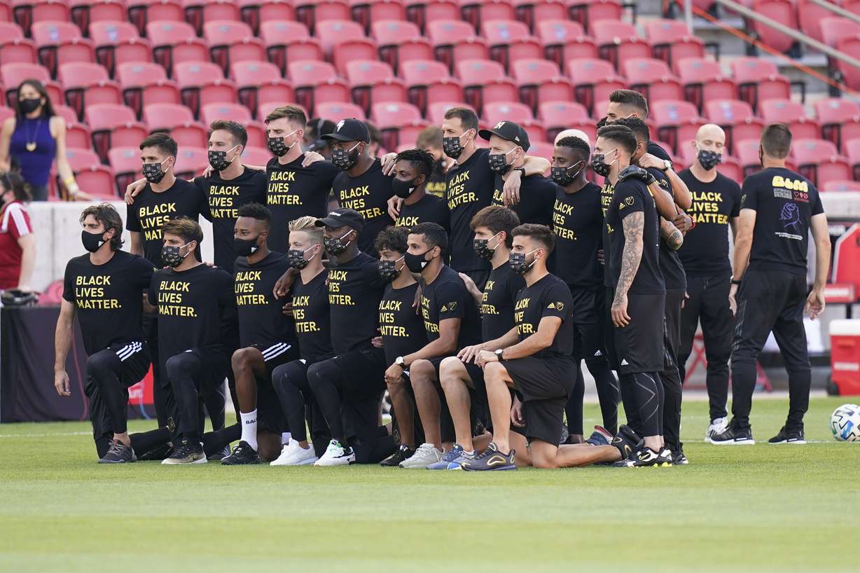 Players from Los Angeles FC pose for a group photo on the field prior to the announcement that their game against Real Salt Lake was called off Wednesday, Aug. 26, 2020, in Sandy, Utah. Major League Soccer players boycotted five games Wednesday night in a collective statement against racial injustice. The players' action came after all three NBA playoff games were called off in a protest over the police shooting of Jacob Blake in Wisconsin on Sunday night.