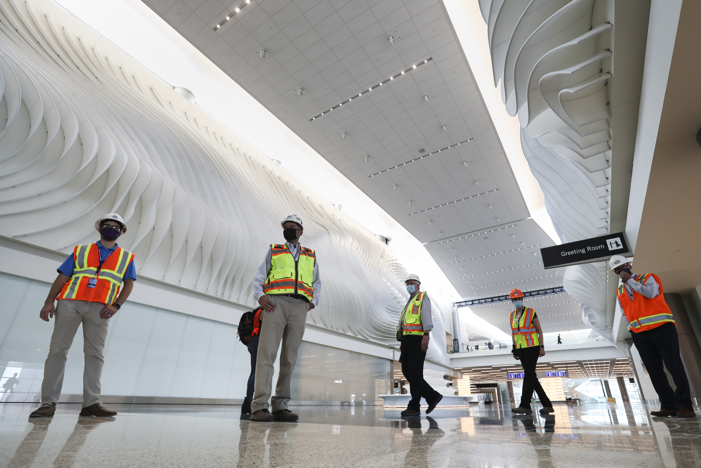Members of the media and dignitaries check out "The Canyon,â a football field-sized installation by California-based artist Gordon Huether, during a tour of the new Salt Lake City International Airportâs main terminal in Salt Lake City on Thursday, Aug. 27, 2020. The new airport is set to open on Sept. 15, 2020.
