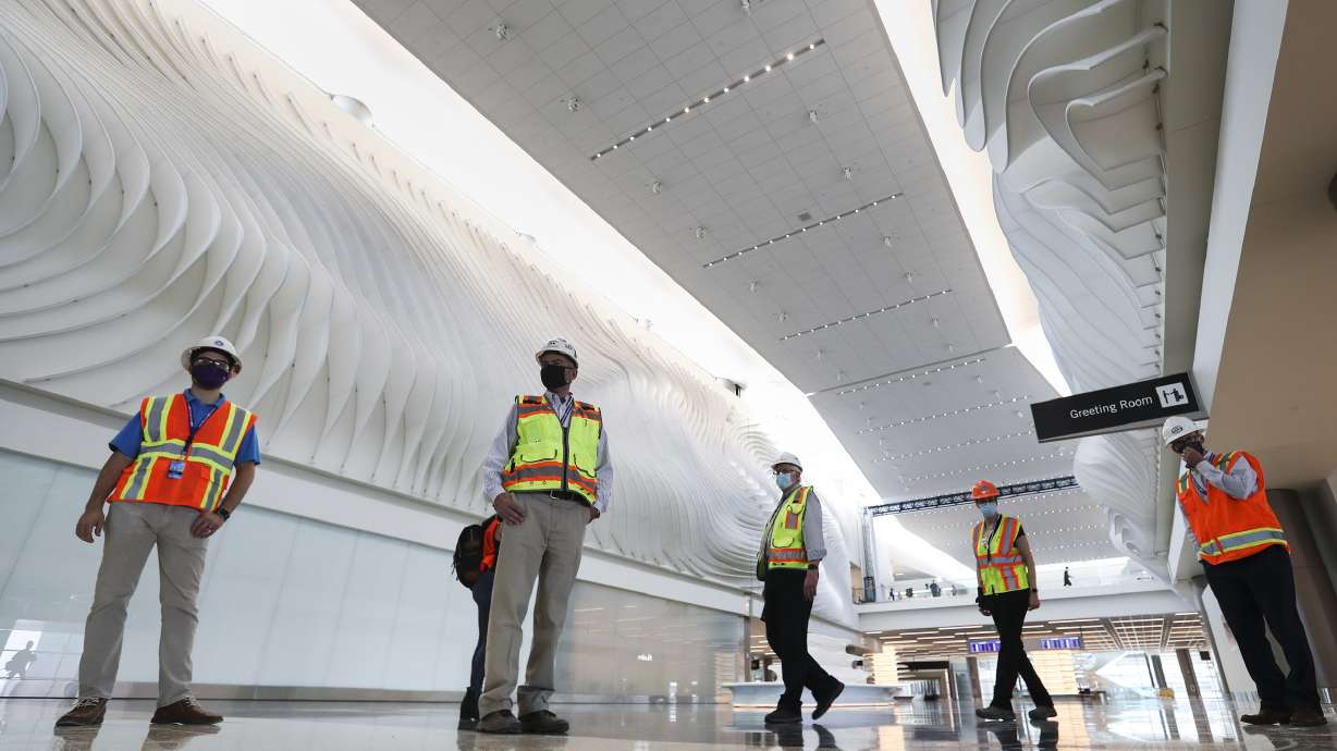 Members of the media and dignitaries check out "The Canyon,â a football field-sized installation by California-based artist Gordon Huether, during a tour of the new Salt Lake City International Airportâs main terminal in Salt Lake City on Thursday, Aug. 27, 2020. The new airport is set to open on Sept. 15, 2020.