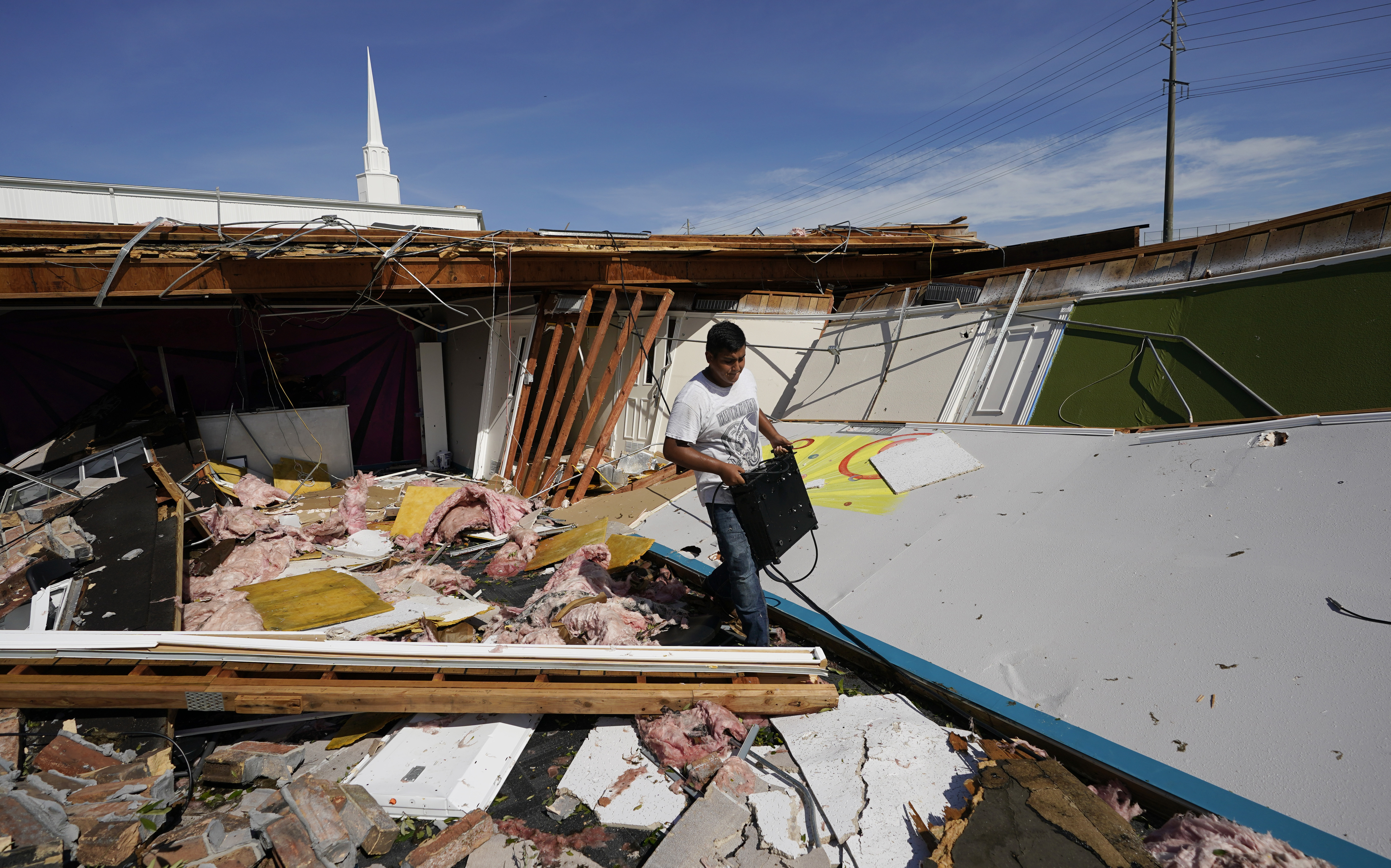 Benjamin Luna helps recover items from the children's wing of the First Pentecostal Church that was destroyed by Hurricane Laura, Thursday, Aug. 27, 2020, in Orange, Texas. (AP Photo/Eric Gay) [Aug-27-2020]