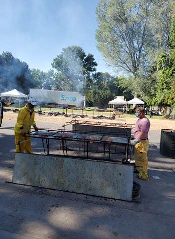 Two men work the grill at the 2020 Salmon Supper in Payson on Friday, Aug 7.