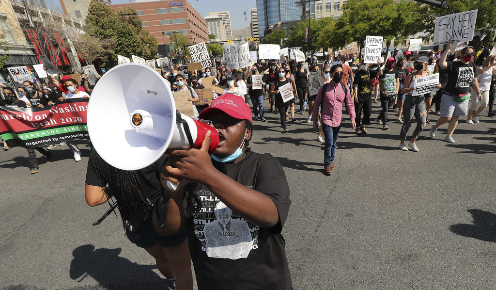 Activists march on State Street in Salt Lake City on Friday, Aug. 28, 2020, to commemorate the 57th anniversary of the historic March on Washington for Jobs and Freedom, where Dr. Martin Luther King Jr. delivered his "I Have a Dream" speech.