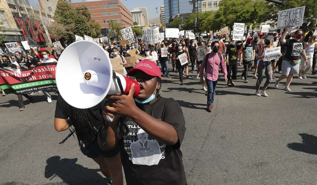 Activists march on State Street in Salt Lake City on Friday, Aug. 28, 2020, to commemorate the 57th anniversary of the historic March on Washington for Jobs and Freedom, where Dr. Martin Luther King Jr. delivered his "I Have a Dream" speech.