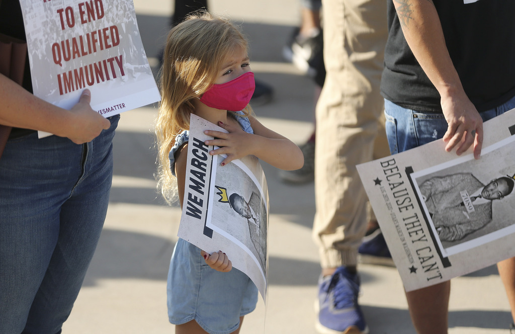 Elliott Hewitt, 4, holds a sign as activists participate in a march in Salt Lake City on Friday, Aug. 28, 2020, to commemorate the 57th anniversary of the historic March on Washington for Jobs and Freedom, where Dr. Martin Luther King Jr. delivered his "I Have a Dream" speech.