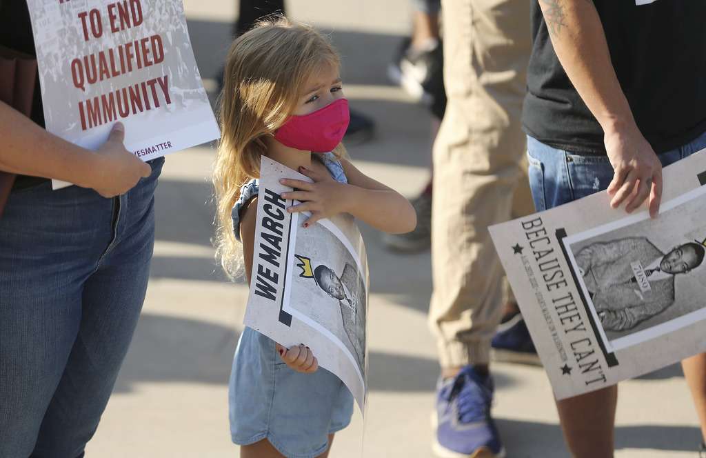 Elliott Hewitt, 4, holds a sign as activists participate in a march in Salt Lake City on Friday, Aug. 28, 2020, to commemorate the 57th anniversary of the historic March on Washington for Jobs and Freedom, where Dr. Martin Luther King Jr. delivered his "I Have a Dream" speech.
