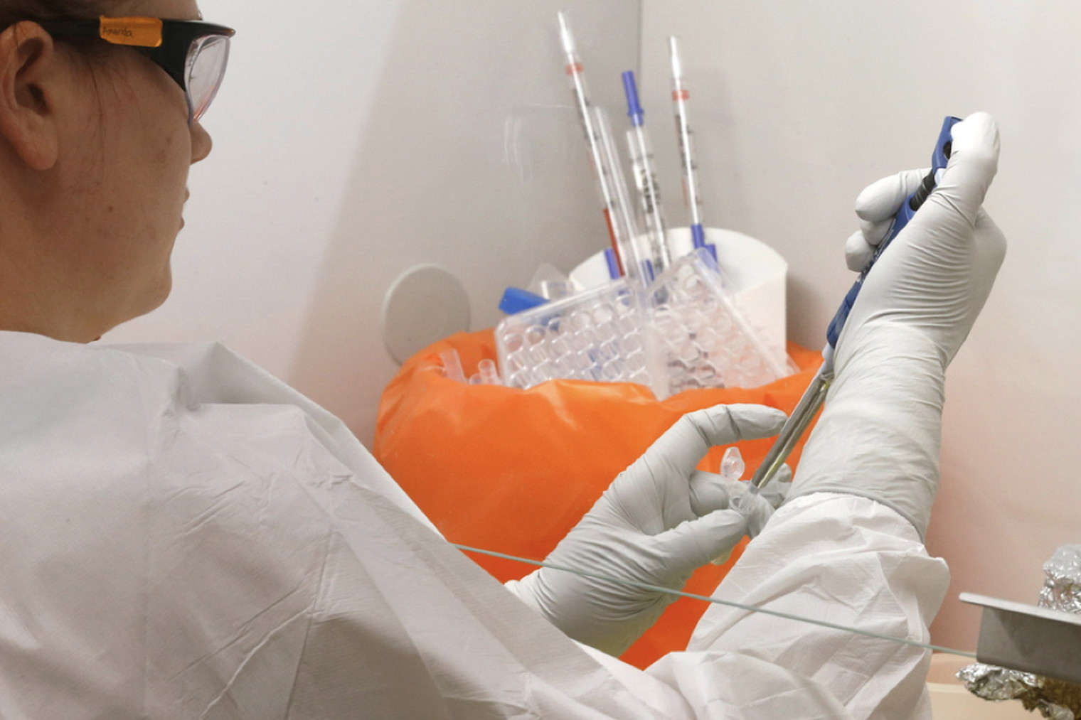 Dr. Amanda Smith, University of Utah, is shown testing drug candidates against HIV in a biosafety cabinet. University of Utah researchers say they have developed a drug that appears to prevent HIV and treat the virus with fewer side effects than therapies currently in use. After successful tests in primates, the drug will soon undergo human trials.