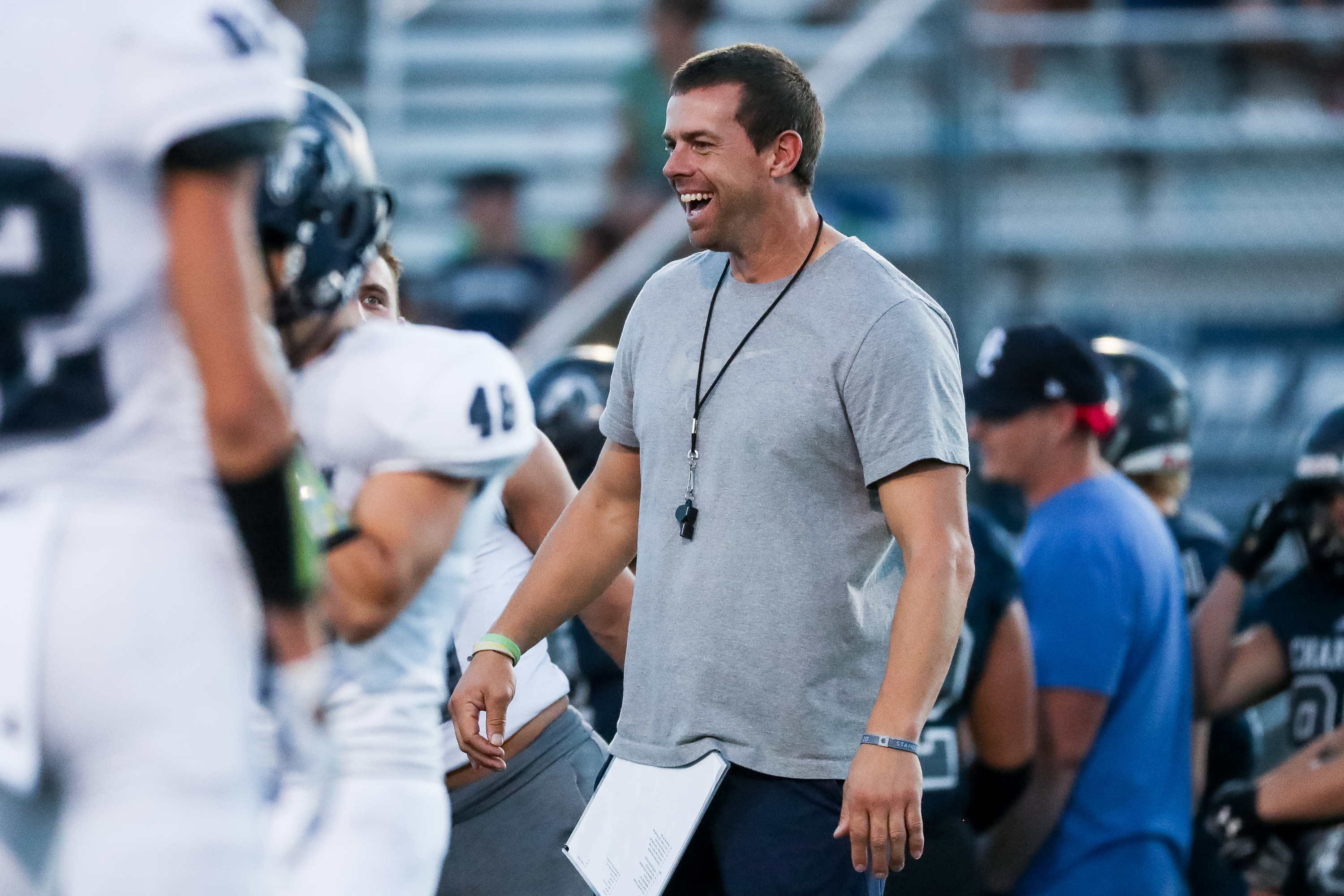 Head coach Eric Kjar warms up with players as Corner Canyon football hosts its annual intrasquad scrimmage in Draper on Friday, Aug. 7, 2020.