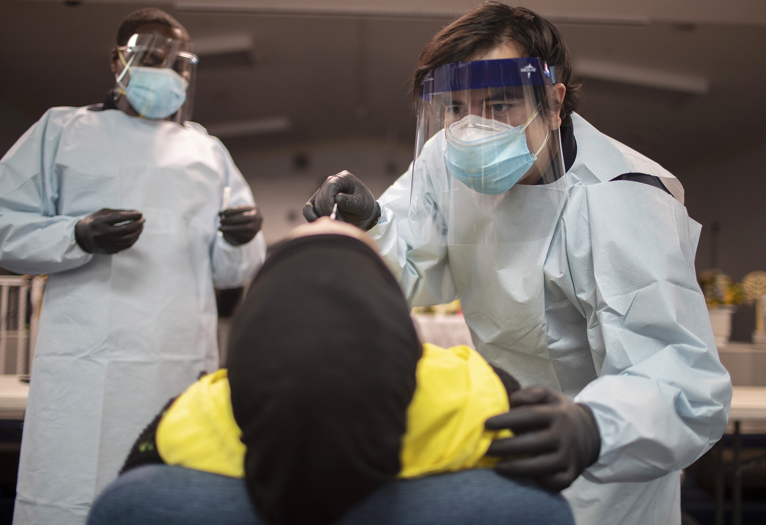Health care workers use a nasal swab to test a person for COVID-19 at a pop up testing site at the Koinonia Worship Center and Village on July 22, 2020 in Pembroke Park, Florida.
