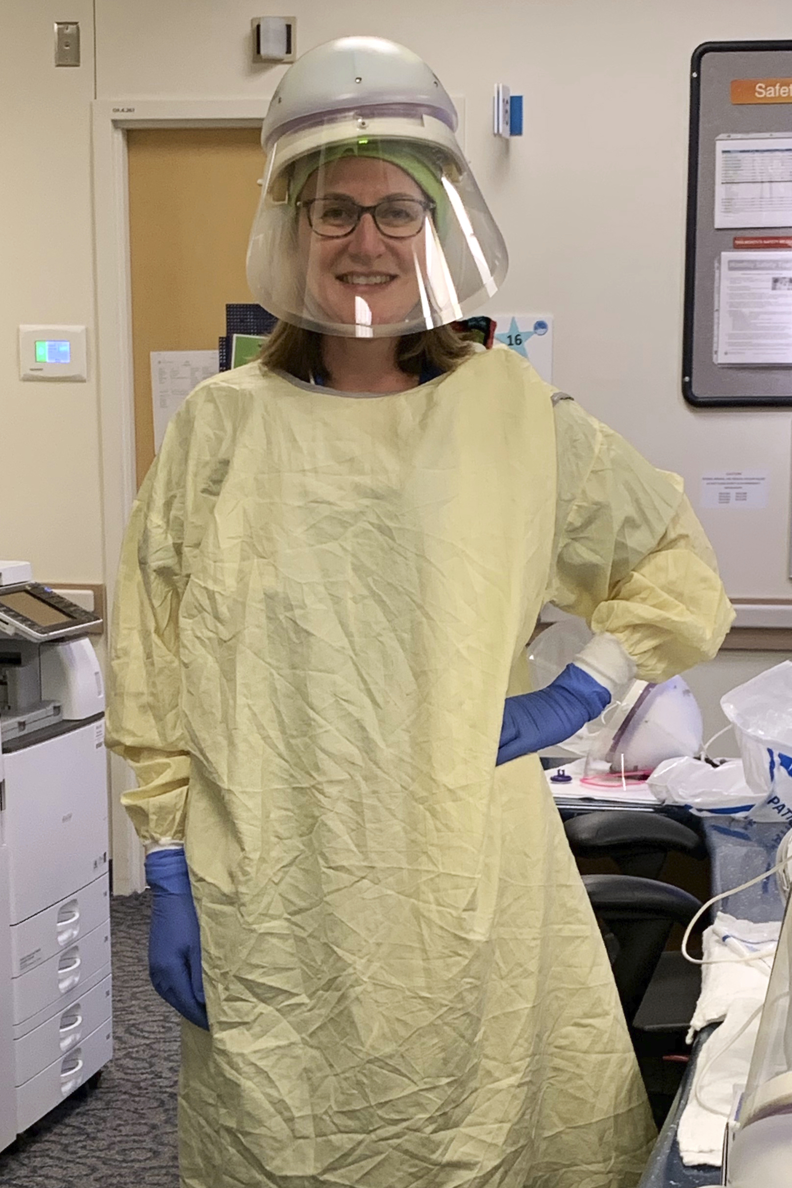 In this undated photo provided by Cassie Docking, she poses at work as an urgent care nurse in Seattle. As the Summer of COVID draws to a close, many experts fear an even bleaker fall and suggest that American families should start planning for Thanksgiving by Zoom.   She is telling her parents — both cancer survivors — that Thanksgiving will be by FaceTime only. “We all want to get to 2021 and if that’s what it takes, that’s what we’ll do,” Docking said. (Courtesy of Cassie Docking via AP) [Aug-31-2020]