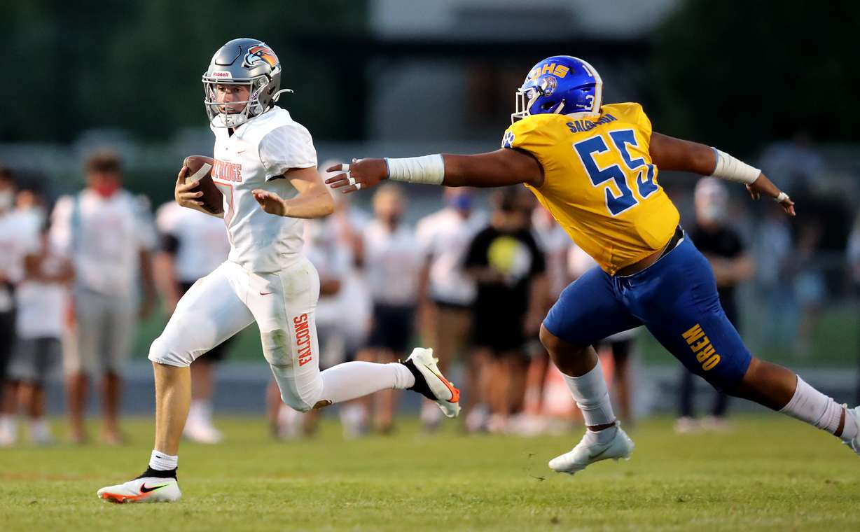 Skyridge’s McCae Hillstead avoids Orem’s Zion Saleapaga on a quarterback keeper as the two teams play in a high school football game in Lehi on Friday, Aug. 28, 2020.