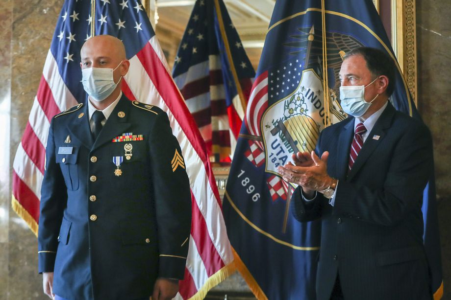 Gov. Gary Herbert applauds for Sgt. Chasen Brown, a service member of the Utah National Guard, after presenting him with the Utah Medal of Valor in the Gold Room at the Utah State Capitol on Tuesday, Sept. 1, 2020. Brown, a gunner for Charlie Battery, 2nd Battalion, 222nd Field Artillery, was attending the Route 91 Harvest music festival in Las Vegas on Oct. 1, 2017. Shortly after the concert started, a man began shooting at the massive crowd. Without hesitation or regard to personal safety, Brown immediately rendered aide to the wounded while under constant gunfire. His actions on that day, also known as one of the deadliest mass shootings in the United States, saved the lives of dozens of fellow concertgoers.