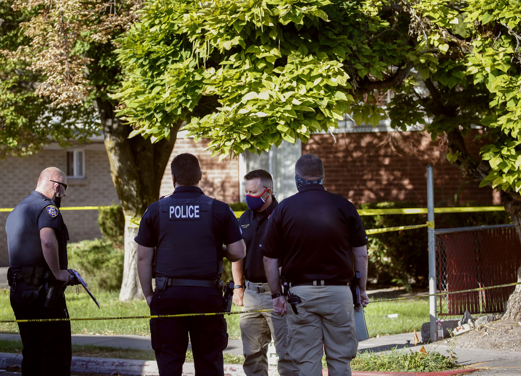 South Salt Lake police officers confer at the scene of a stabbing in South Salt Lake on Wednesday, Sept. 2, 2020. A 70-year-old suspect is in custody after a person was found dead inside an apartment at 2880 S. 200 East.
