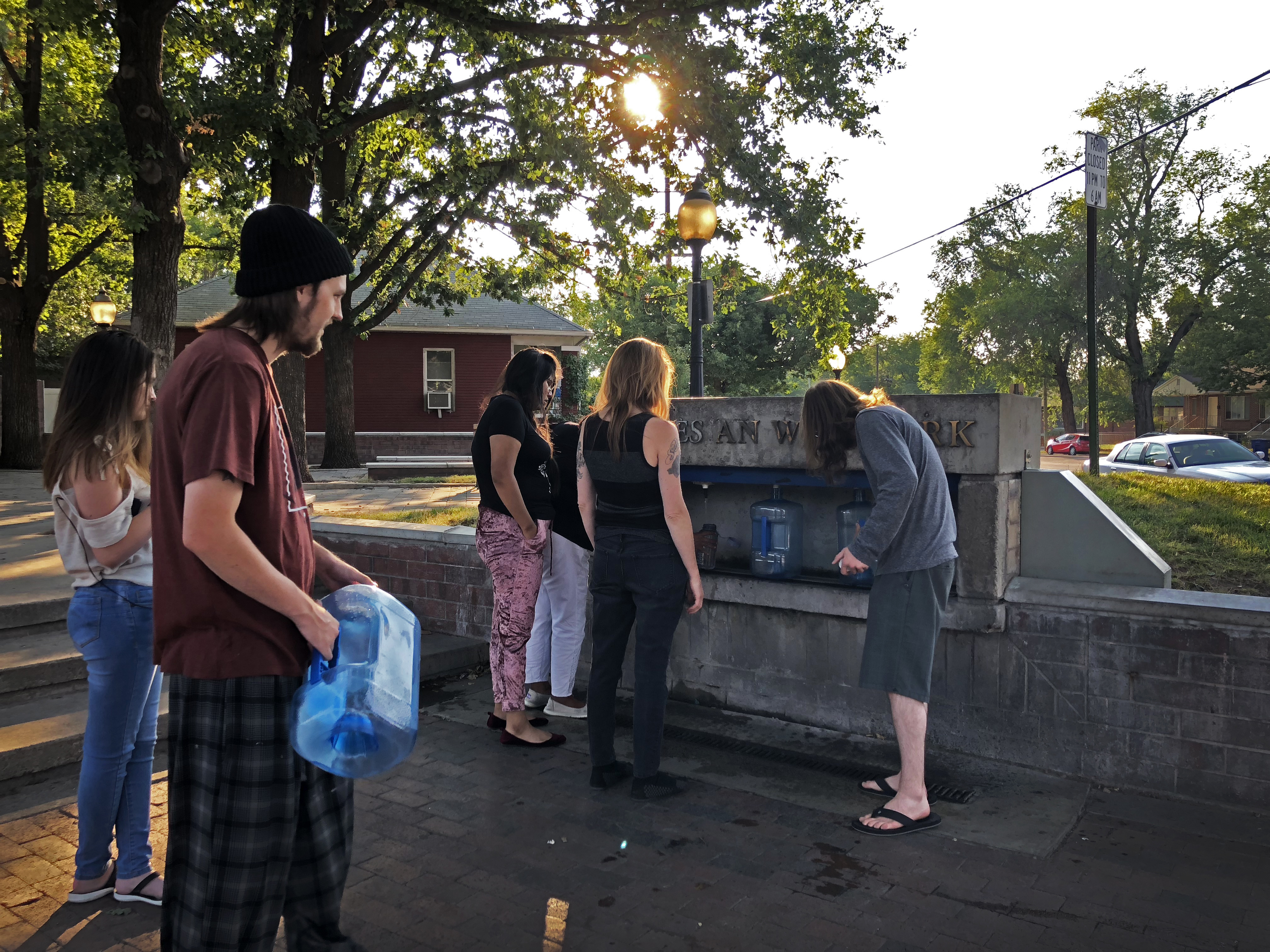 People line up to fill their water containers at the Artesian Well Park in Salt Lake City in July 2018.