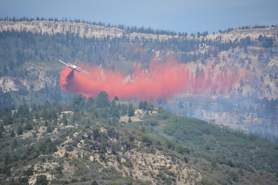 A plane drops fire retardant to stop the Cowboy Fire in central Utah on Aug. 21, 2020.
