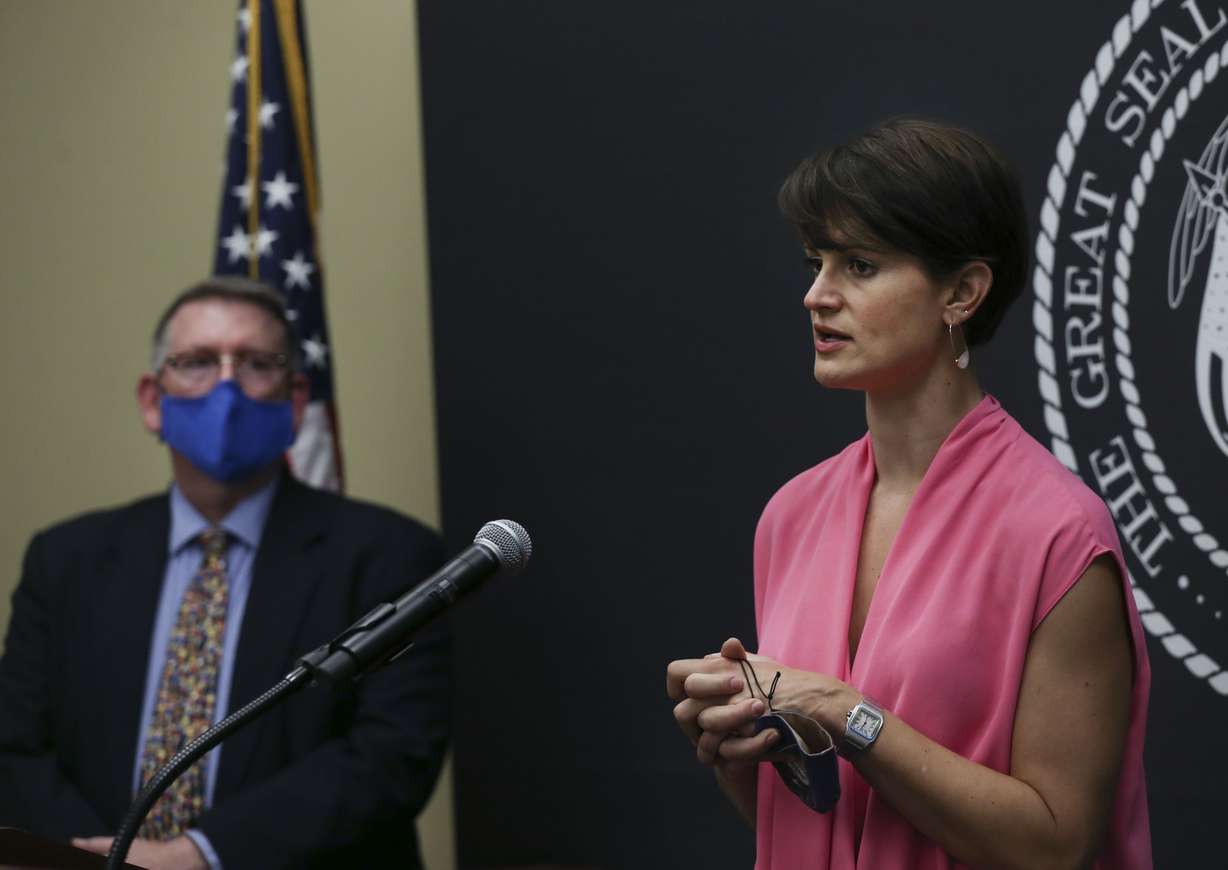 Erik Christensen, chief medical examiner for the Utah Department of Health, left, listens as Angela Dunn, state epidemiologist with the Utah Department of Health, speaks at the COVID-19 briefing at the Capitol in Salt Lake City on Thursday, Sept. 3, 2020.