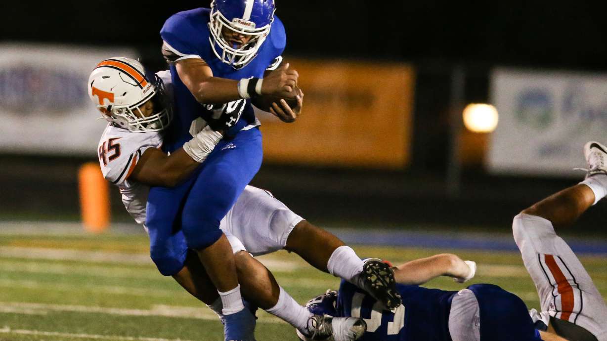 Bingham's Saia Lomu (2) carries the ball against Timpview's Taylor Malo (45) during a high school football game at Bingham High School in South Jordan on Thursday, Sept. 3, 2020.