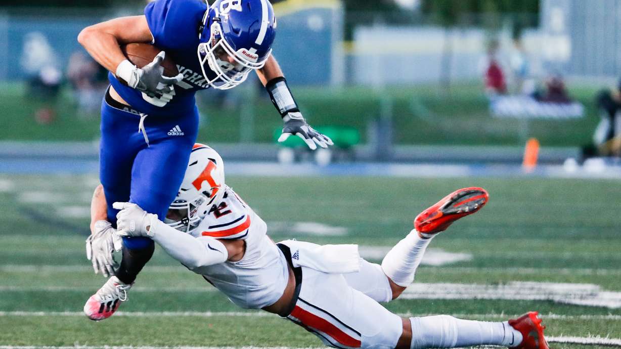 Bingham’s Parker Gurr (5) hurdles agains Timpview’s Elijah Allen (2) during a high school football game at Bingham High School in South Jordan on Thursday, Sept. 3, 2020.