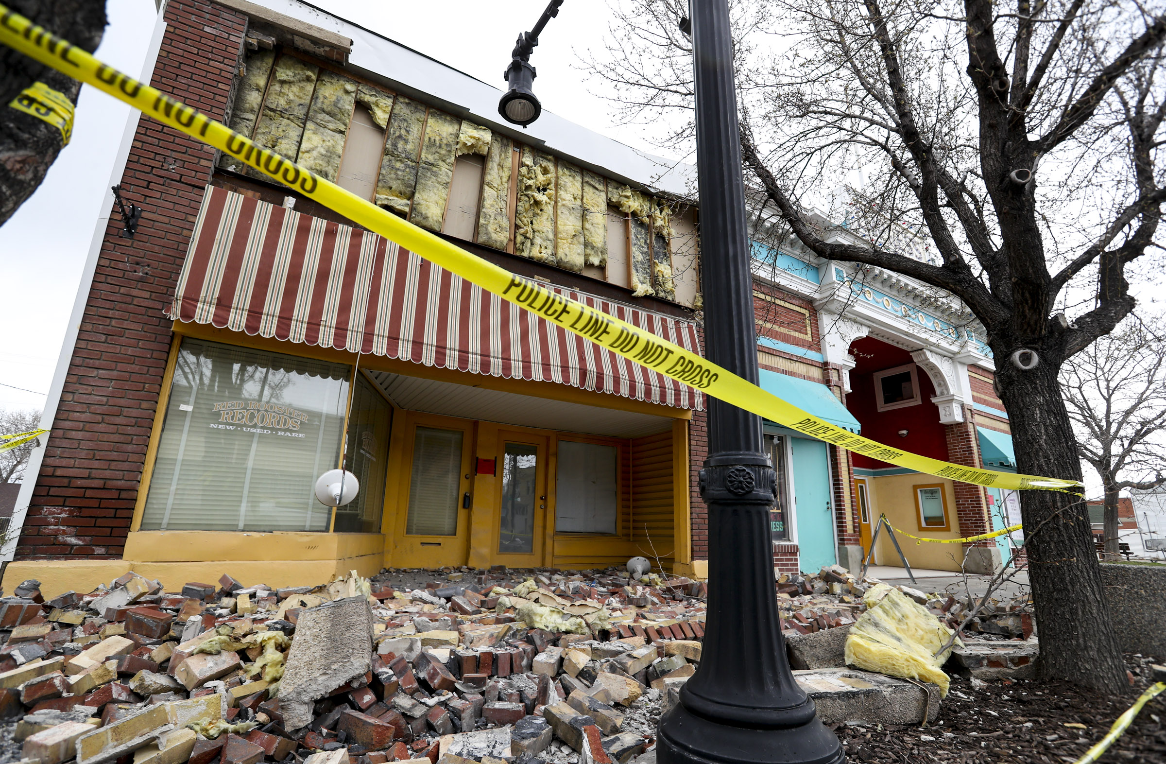 Caution tape surrounds a damaged building on Magnaâs Main Street on Tuesday, March 24, 2020, following a 5.7 magnitude earthquake that was centered near the city on March 18. The street is now open to traffic.