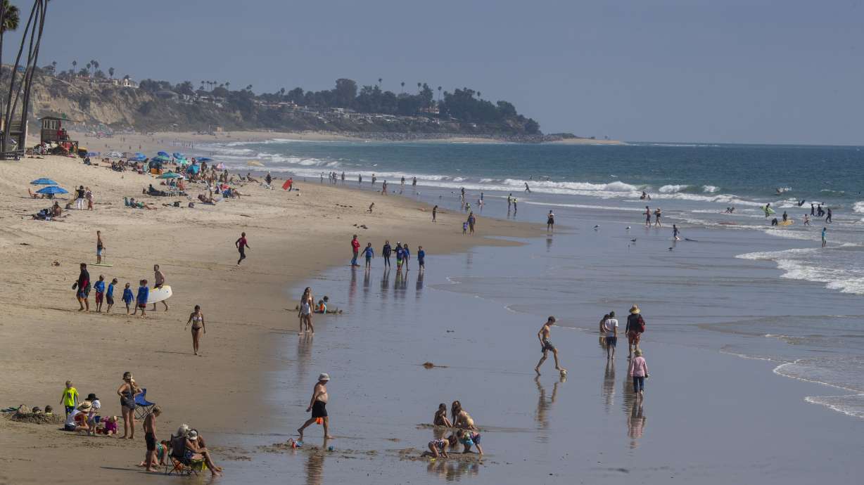 Beachgoers enjoy a warm sunny day ahead of the Labor Day holiday weekend near the San Clemente pier in California on Wednesday, September 2.