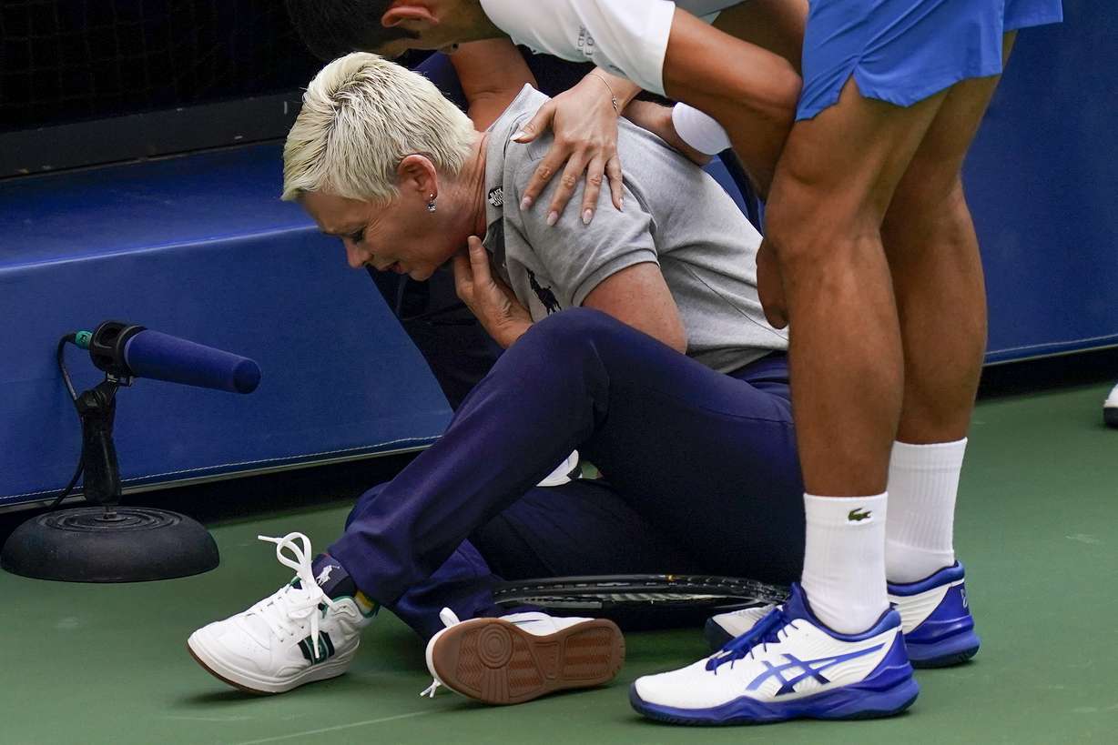 Novak Djokovic, of Serbia, checks a line judge after inadvertently hitting her with a ball in reaction to losing a point to Pablo Carreno Busta, of Spain, during the fourth round of the US Open tennis championships, Sunday, Sept. 6, 2020, in New York. Djokovic defaulted the match.