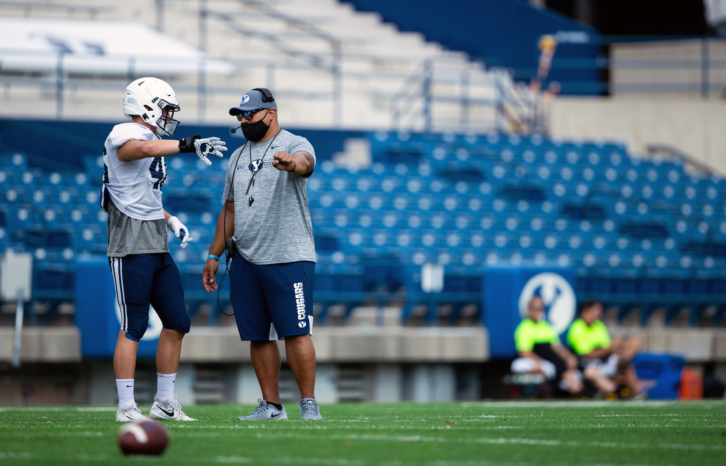 BYU coach Kalani Sitake speaks with linebacker Drew Jensen during a team scrimmage, Aug. 20, 2020 at LaVell Edwards Stadium in Provo.