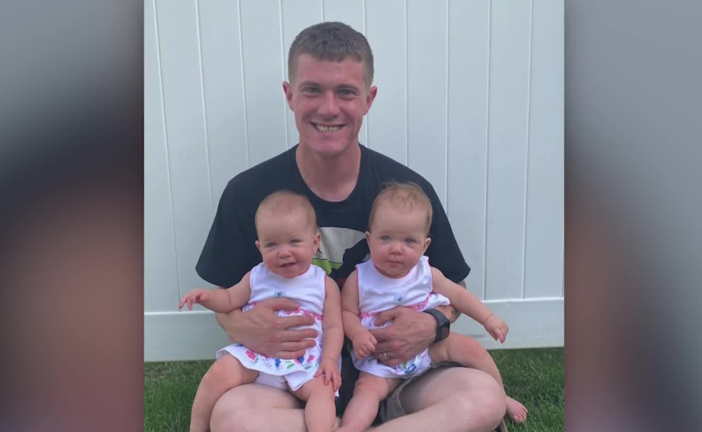 Jesse Nagle holds his twin daughters in a family photo.