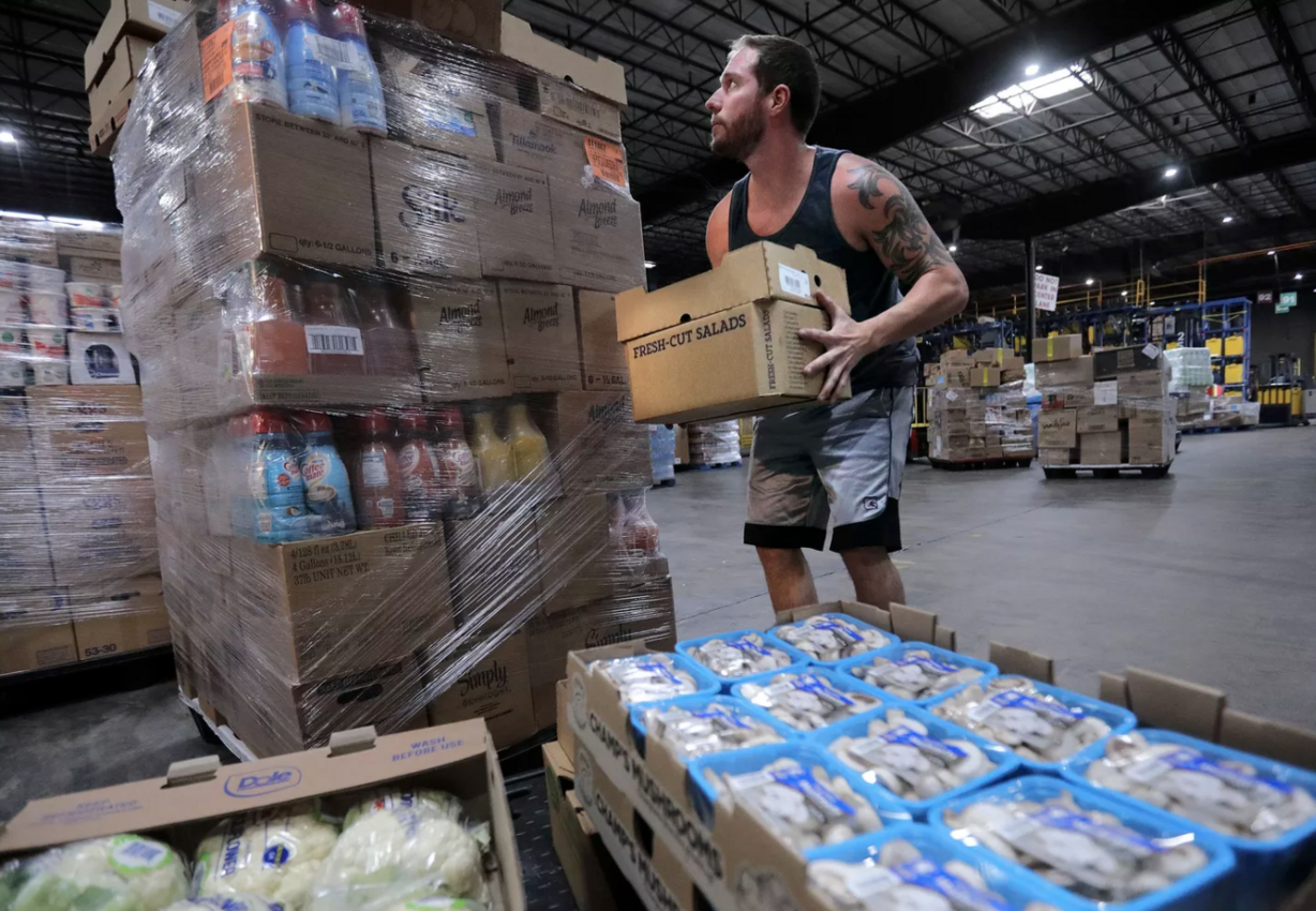 Jesse Stocks, Associated Foods senior distribution specialist/loader, moves produce at the Associated Foods distribution warehouse in Farr West, Weber County, on Wednesday, Aug. 19, 2020.