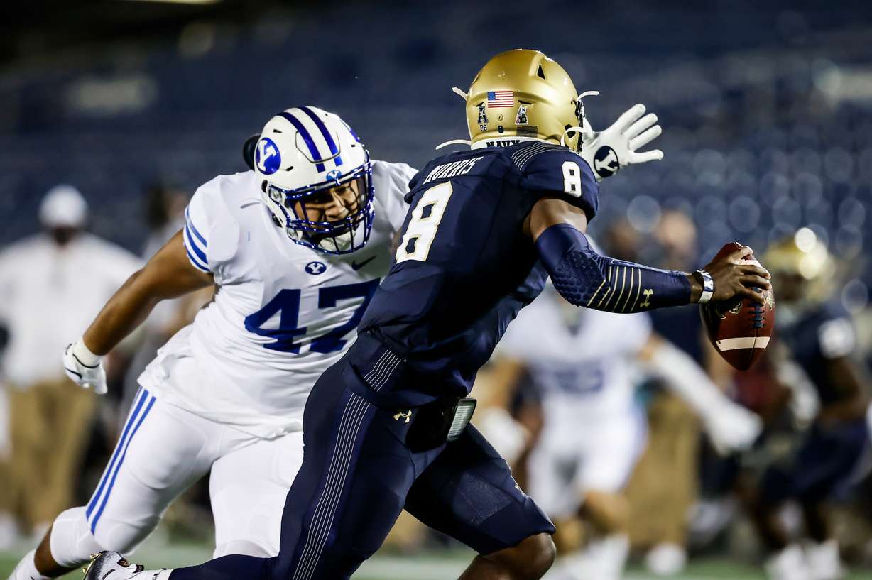 BYU linebacker Pepe Tanuvasa pressures Navy quarterback Dalen Morris during the first half of an NCAA college football game, Saturday, Sept. 7, 2020 in Annapolis, Maryland.