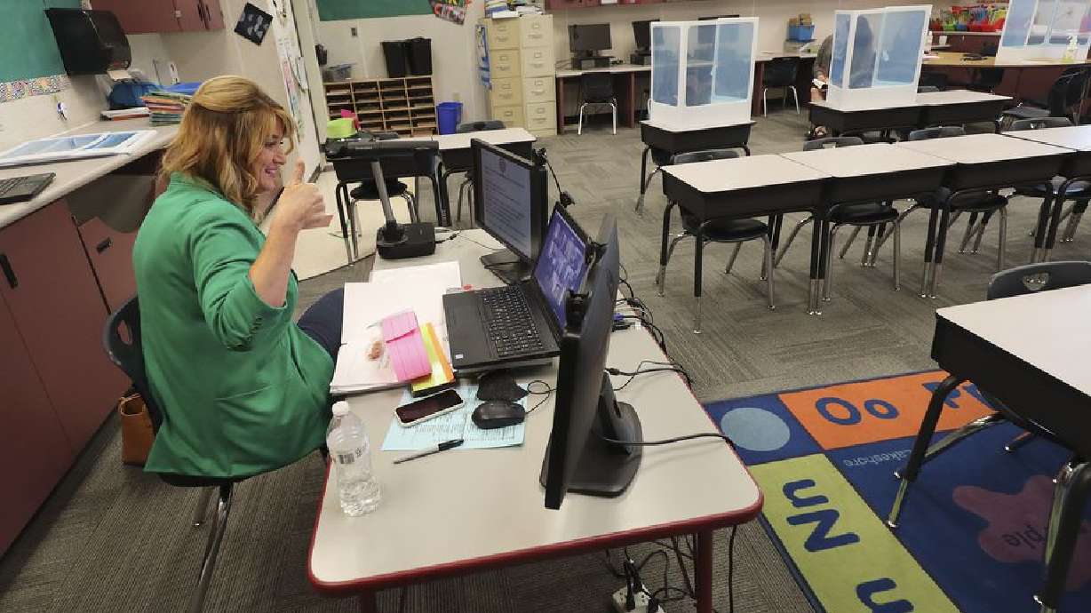 Jeni Larsen, a third grade teacher at Parkview Elementary School in Salt Lake City, gives a thumbs up to her students online on the first day of school in Salt Lake City on Tuesday, Sept. 8, 2020.