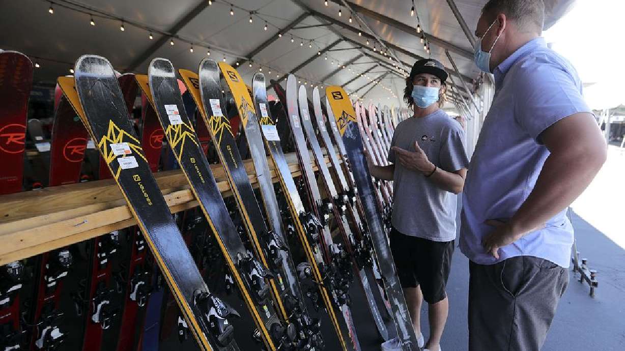 Drew Pectol, Ski ’N See Bountiful store manager, helps Peter Harrison pick out skis at Ski ’N See’s annual sale in the parking lot outside of Ski ’N See in Sandy on Friday, Sept. 4, 2020.