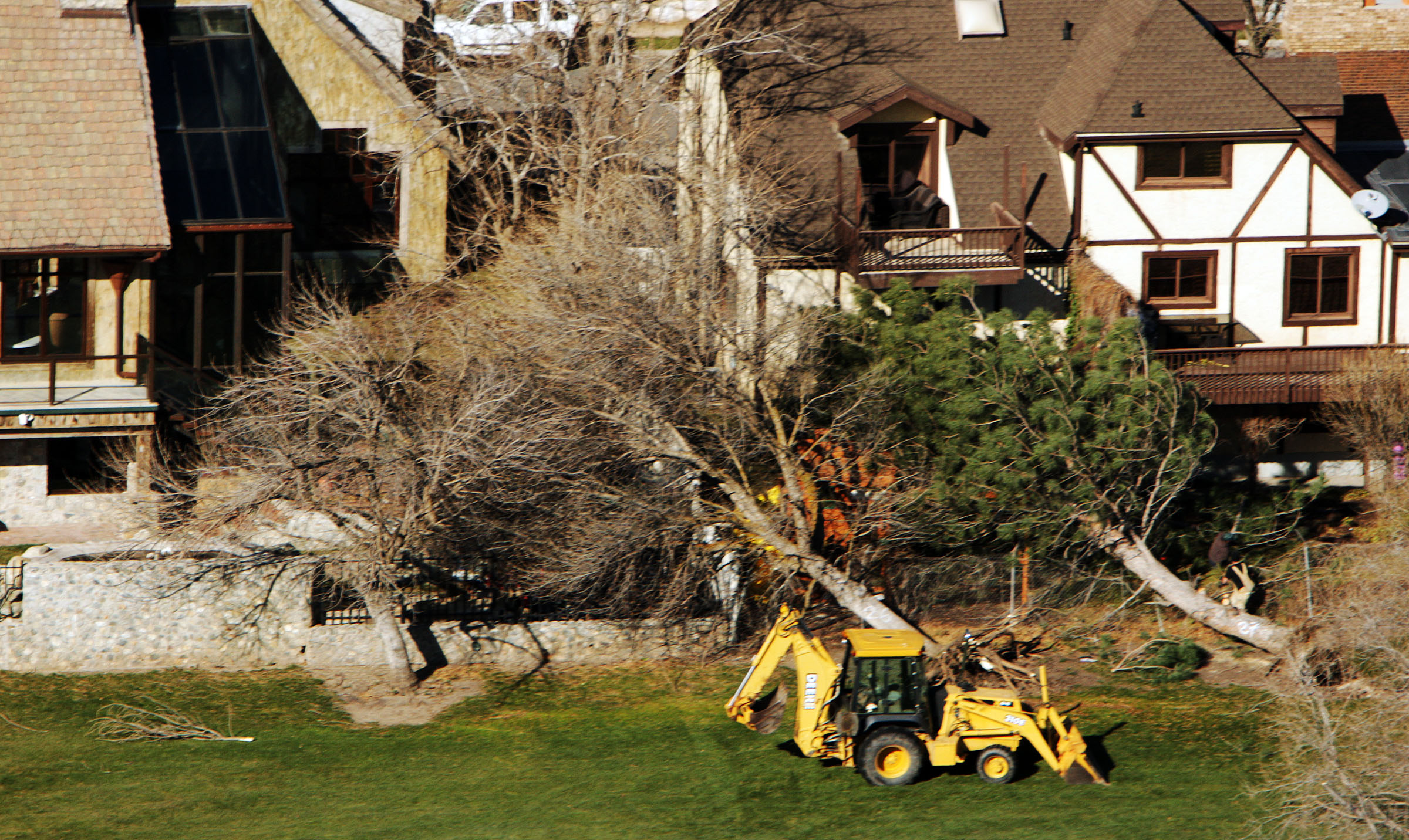 Residents assess damage after a wind storm hit Davis County homes, businesses, construction and golf courses Friday, Dec. 2, 2011.