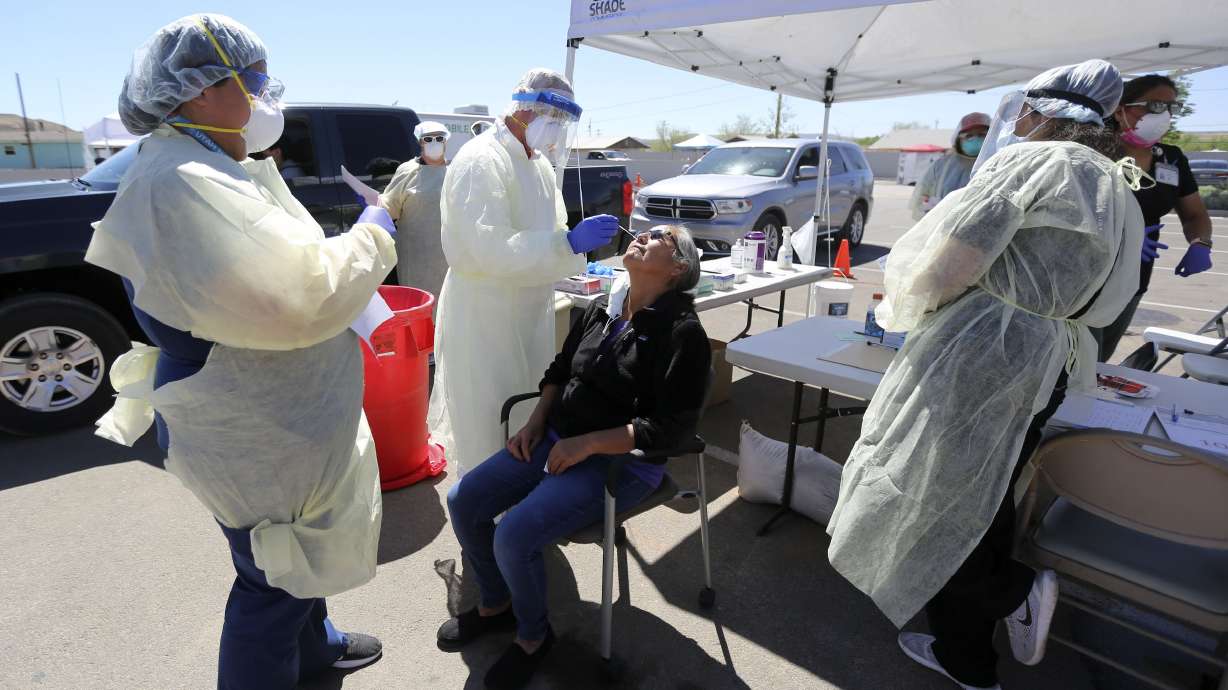 Andy Byrnes, a contracted EMT with the Utah Department of Health, tests Darlene Eddie, Utah Navajo Health System outreach supervisor, for COVID-19 outside of the Montezuma Creek Community Health Center in Montezuma Creek, San Juan County, on Friday, May 1, 2020.