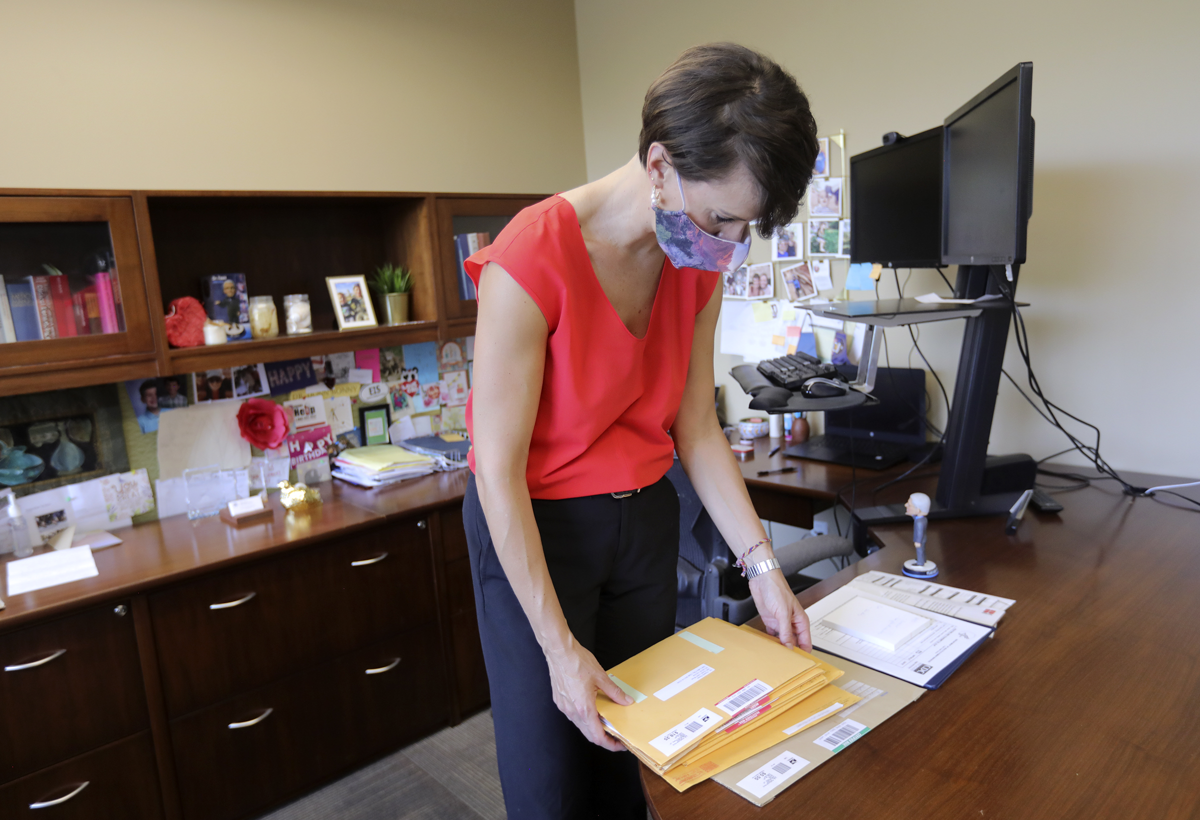 State epidemiologist Dr. Angela Dunn shows a stack of notices of liability in her office at the Utah Department of Health in Salt Lake City on Monday, Aug. 24, 2020. The notices were sent from people who think she's violating their freedom.