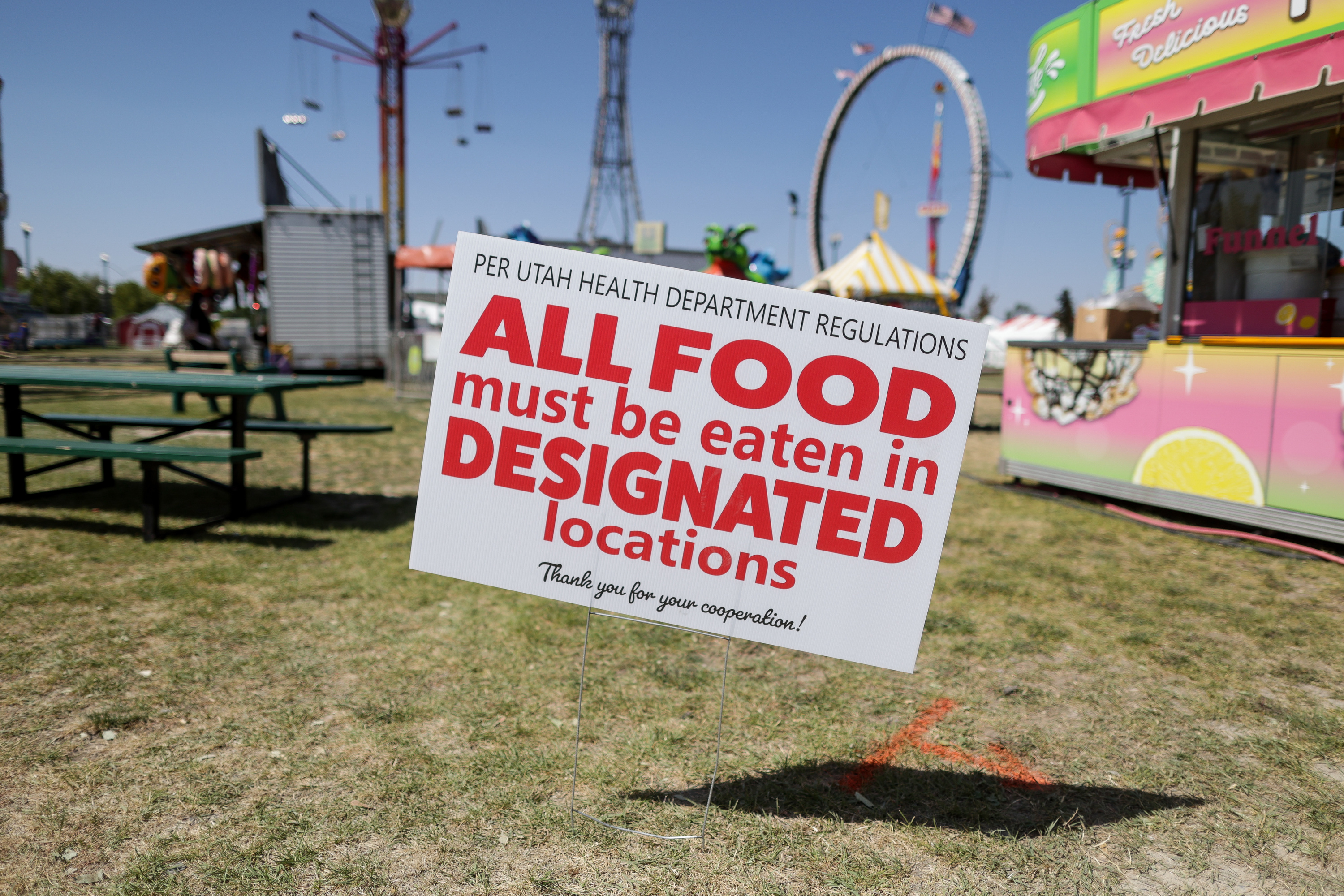 A sign indicates that people must eat only in designated areas, part of the Utah State Fair’s COVID-19 precautions, at the fairpark in Salt Lake City on Friday, Sept. 11, 2020.